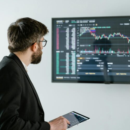 Man in Black Suit Jacket Holding Ipad